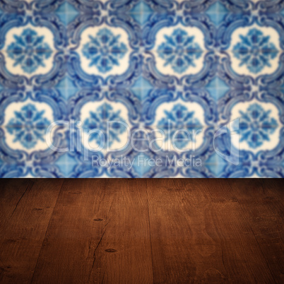 Wood table top and blur vintage ceramic tile pattern wall