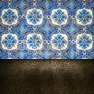 Wood table top and blur vintage ceramic tile pattern wall