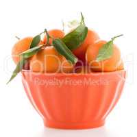 Tangerines on ceramic orange bowl