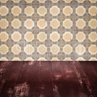 Wood table top and blur vintage ceramic tile pattern wall