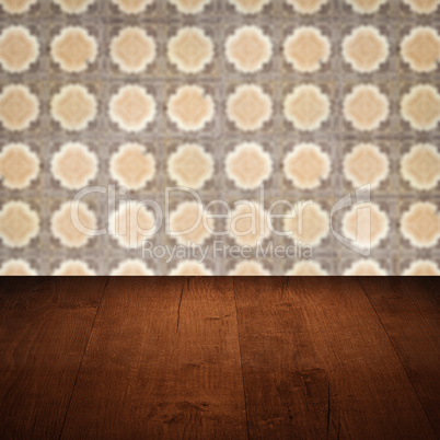 Wood table top and blur vintage ceramic tile pattern wall