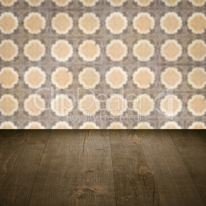 Wood table top and blur vintage ceramic tile pattern wall