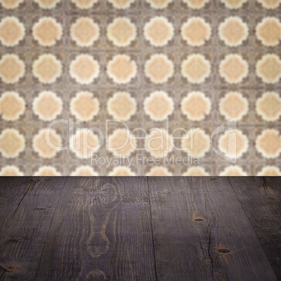 Wood table top and blur vintage ceramic tile pattern wall