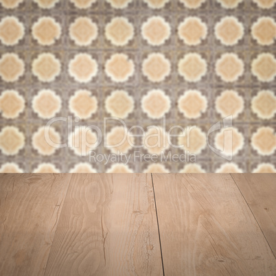 Wood table top and blur vintage ceramic tile pattern wall