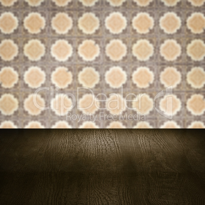 Wood table top and blur vintage ceramic tile pattern wall