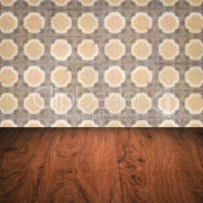 Wood table top and blur vintage ceramic tile pattern wall