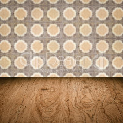 Wood table top and blur vintage ceramic tile pattern wall