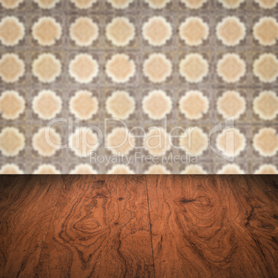 Wood table top and blur vintage ceramic tile pattern wall