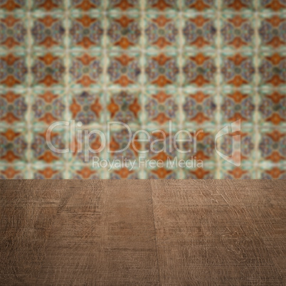 Wood table top and blur vintage ceramic tile pattern wall