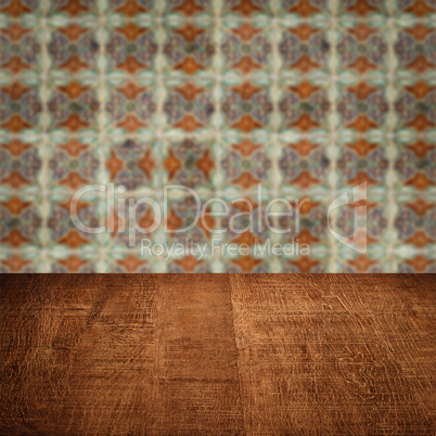 Wood table top and blur vintage ceramic tile pattern wall