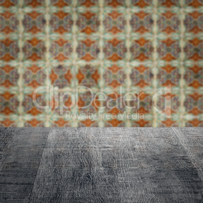 Wood table top and blur vintage ceramic tile pattern wall Wood table top and blur vintage ceramic tile pattern wall