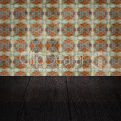 Wood table top and blur vintage ceramic tile pattern wall