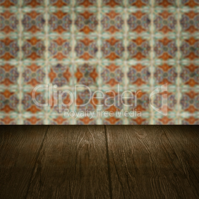 Wood table top and blur vintage ceramic tile pattern wall