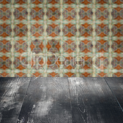 Wood table top and blur vintage ceramic tile pattern wall