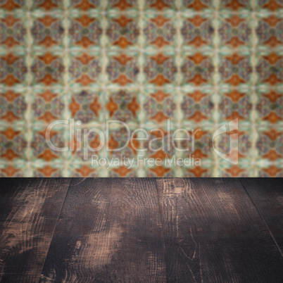 Wood table top and blur vintage ceramic tile pattern wall