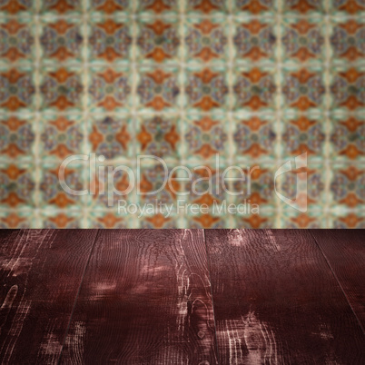 Wood table top and blur vintage ceramic tile pattern wall