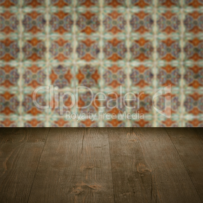 Wood table top and blur vintage ceramic tile pattern wall Wood table top and blur vintage ceramic tile pattern wall