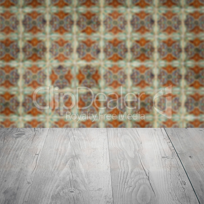 Wood table top and blur vintage ceramic tile pattern wall