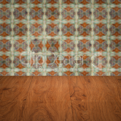 Wood table top and blur vintage ceramic tile pattern wall Wood table top and blur vintage ceramic tile pattern wall