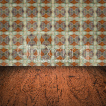 Wood table top and blur vintage ceramic tile pattern wall Wood table top and blur vintage ceramic tile pattern wall