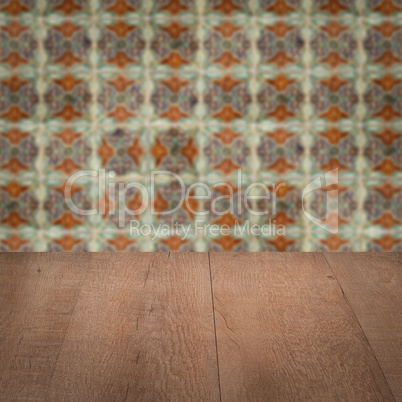 Wood table top and blur vintage ceramic tile pattern wall Wood table top and blur vintage ceramic tile pattern wall