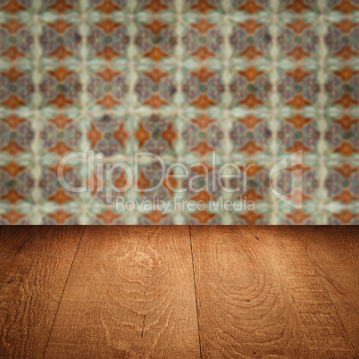 Wood table top and blur vintage ceramic tile pattern wall