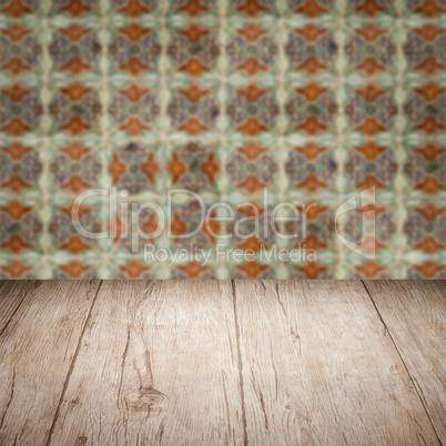 Wood table top and blur vintage ceramic tile pattern wall