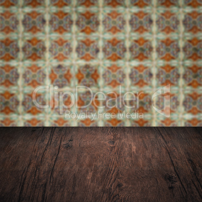 Wood table top and blur vintage ceramic tile pattern wall