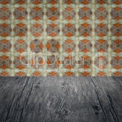 Wood table top and blur vintage ceramic tile pattern wall