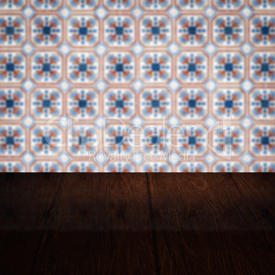 Wood table top and blur vintage ceramic tile pattern wall Wood table top and blur vintage ceramic tile pattern wall