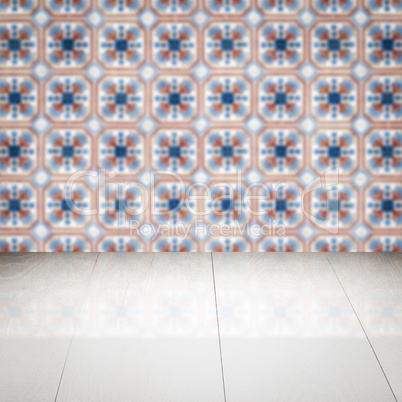 Wood table top and blur vintage ceramic tile pattern wall