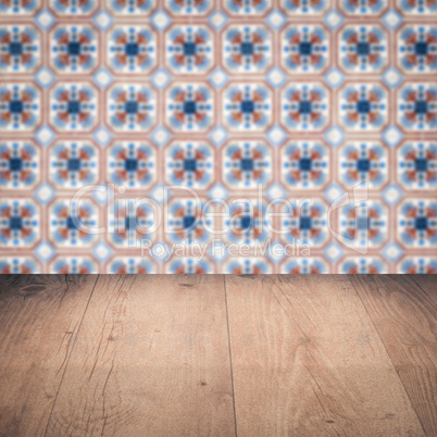 Wood table top and blur vintage ceramic tile pattern wall