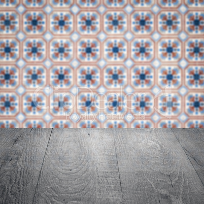 Wood table top and blur vintage ceramic tile pattern wall