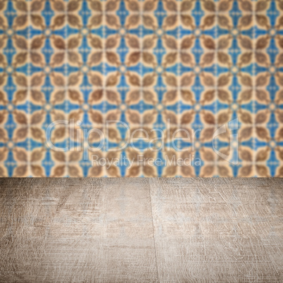 Wood table top and blur vintage ceramic tile pattern wall