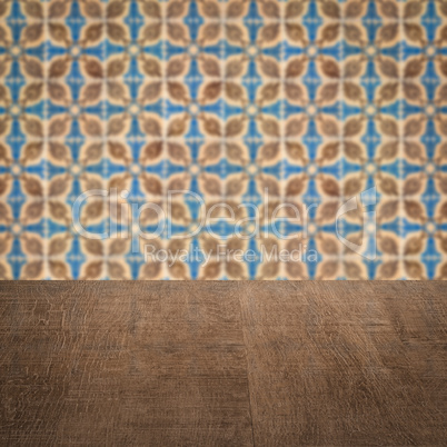 Wood table top and blur vintage ceramic tile pattern wall