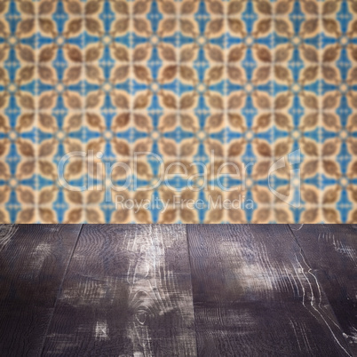 Wood table top and blur vintage ceramic tile pattern wall