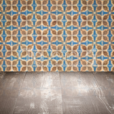 Wood table top and blur vintage ceramic tile pattern wall