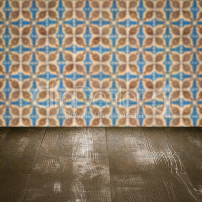 Wood table top and blur vintage ceramic tile pattern wall