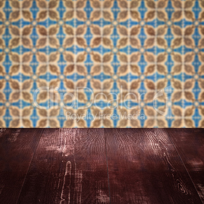 Wood table top and blur vintage ceramic tile pattern wall