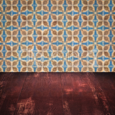 Wood table top and blur vintage ceramic tile pattern wall