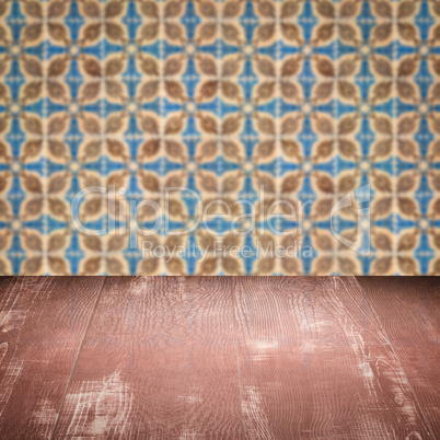 Wood table top and blur vintage ceramic tile pattern wall