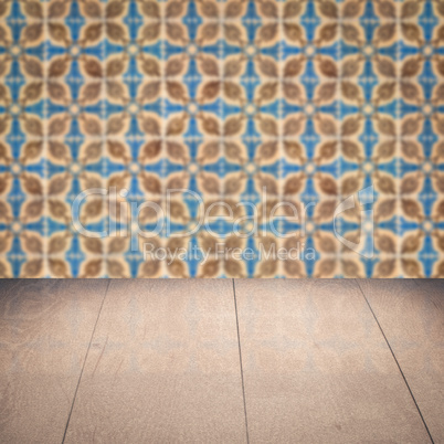 Wood table top and blur vintage ceramic tile pattern wall