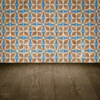 Wood table top and blur vintage ceramic tile pattern wall