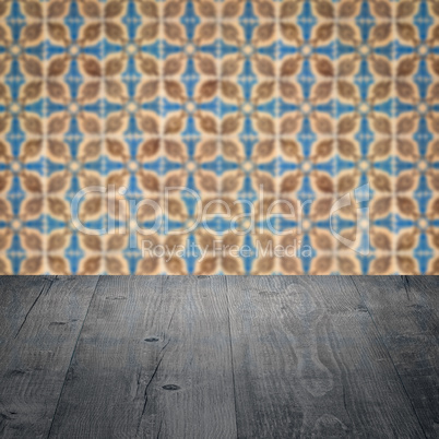 Wood table top and blur vintage ceramic tile pattern wall