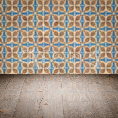 Wood table top and blur vintage ceramic tile pattern wall