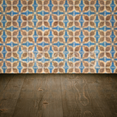 Wood table top and blur vintage ceramic tile pattern wall Wood table top and blur vintage ceramic tile pattern wall