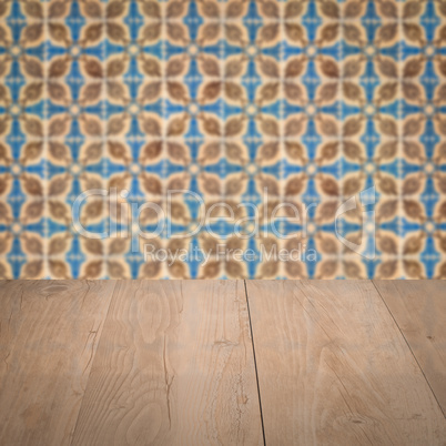 Wood table top and blur vintage ceramic tile pattern wall