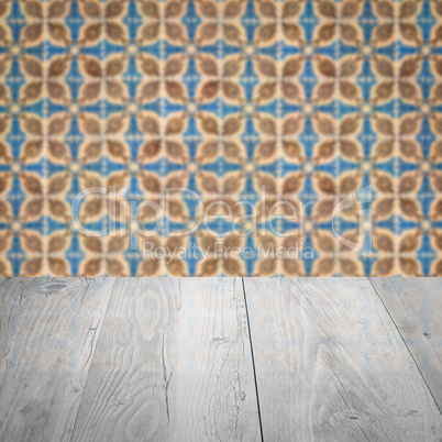 Wood table top and blur vintage ceramic tile pattern wall