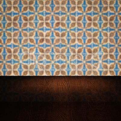 Wood table top and blur vintage ceramic tile pattern wall