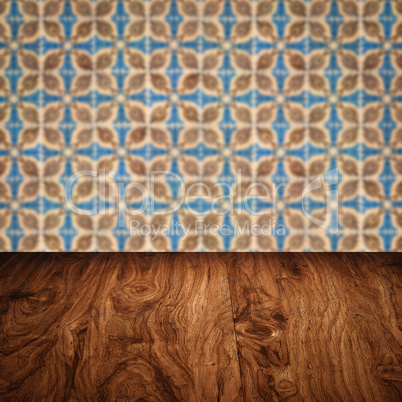 Wood table top and blur vintage ceramic tile pattern wall